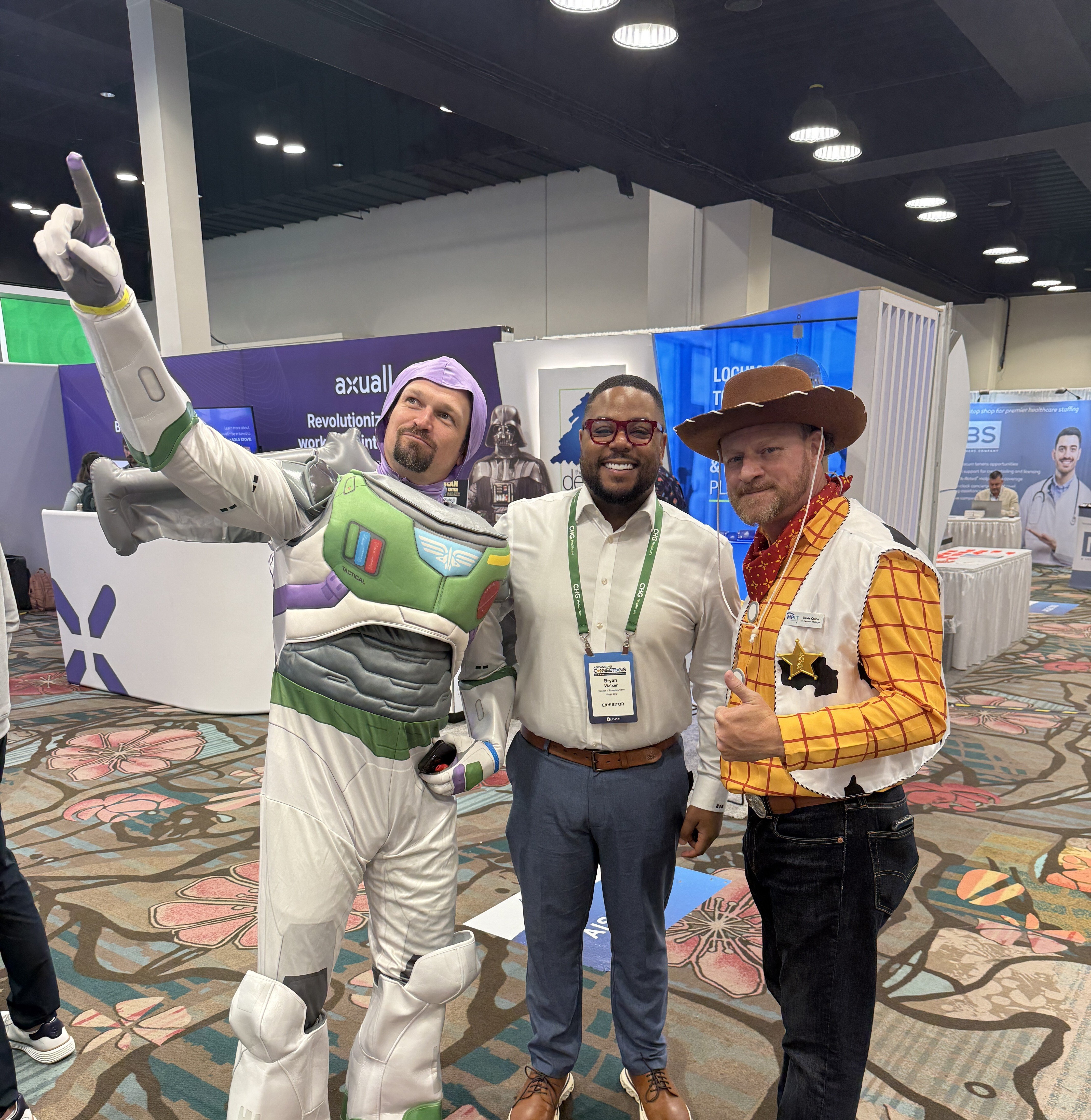 AAPPR conference attendees posing with themed characters, creating an engaging and fun networking experience on the exhibit floor.