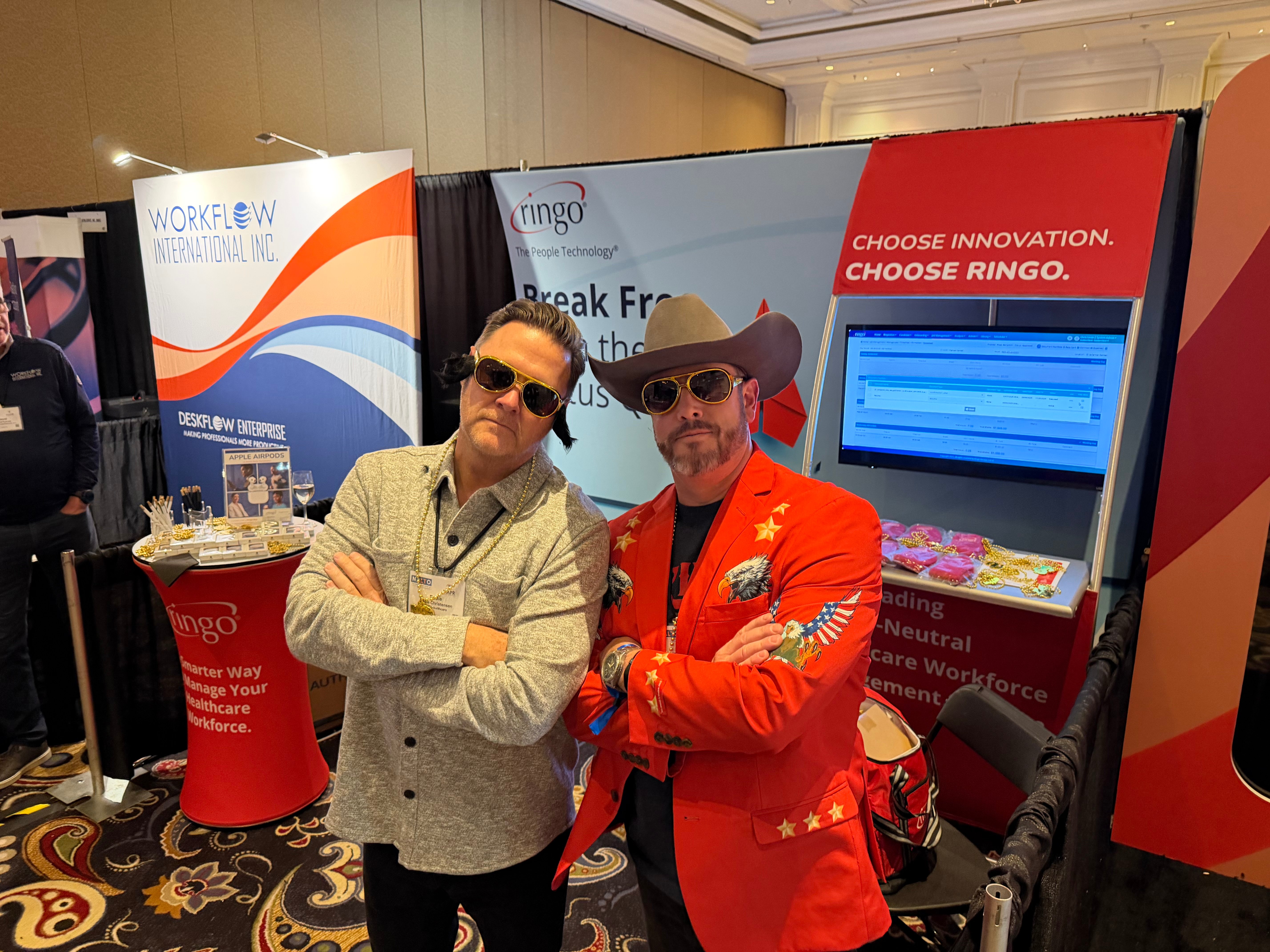 Ringo team member - Milan with guest at Booth 403 during NALTO/NAPR 2026 in Las Vegas showcasing vendor-neutral healthcare workforce management technology and healthcare staffing solutions.