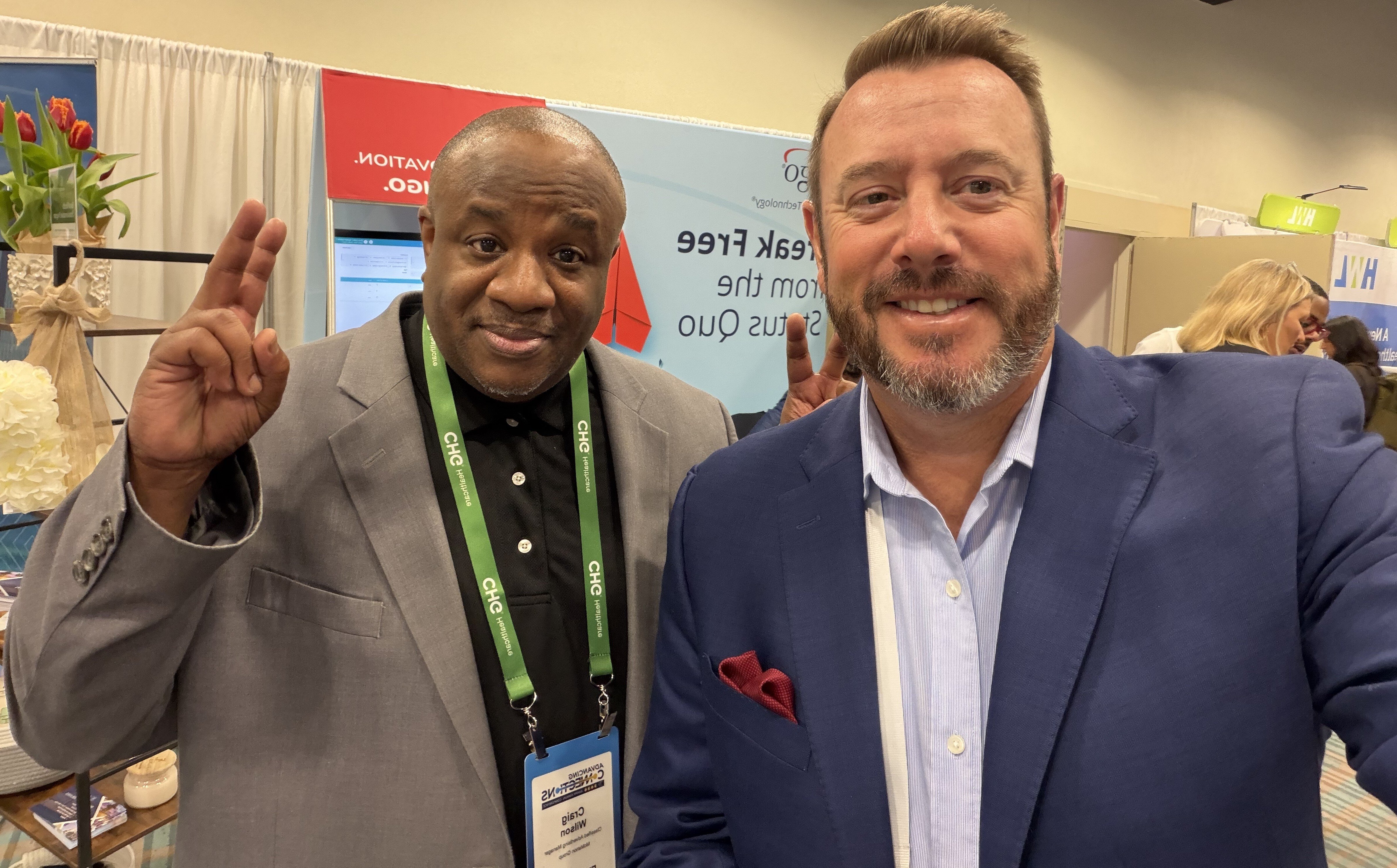 Healthcare leaders at AAPPR conference posing for a selfie on the exhibit floor, connecting and discussing workforce solutions.