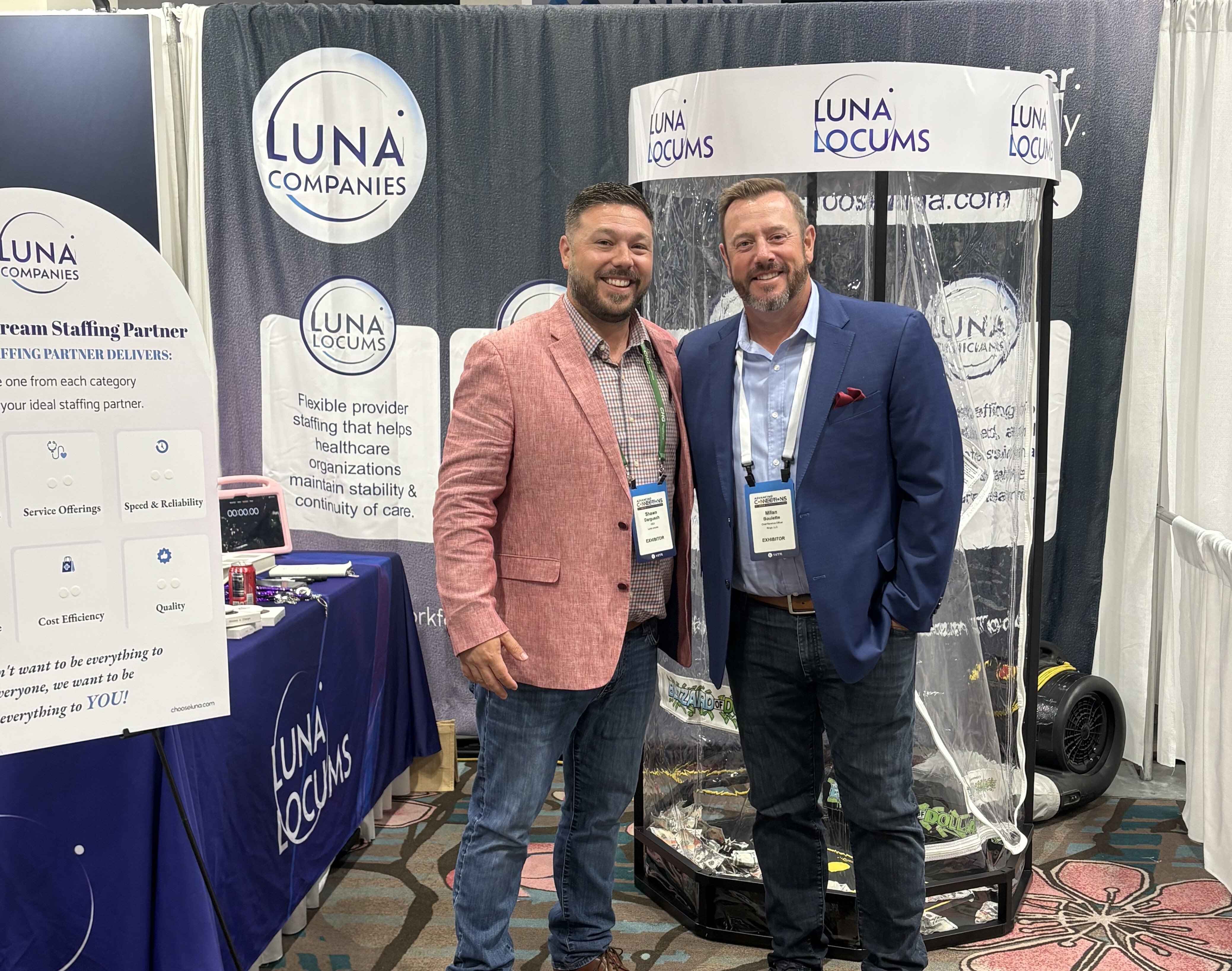 Healthcare staffing professionals networking at AAPPR conference booth, exploring locum tenens and workforce staffing solutions.