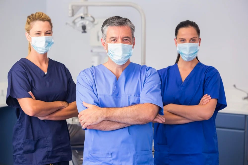 Three healthcare professionals in a hospital setting