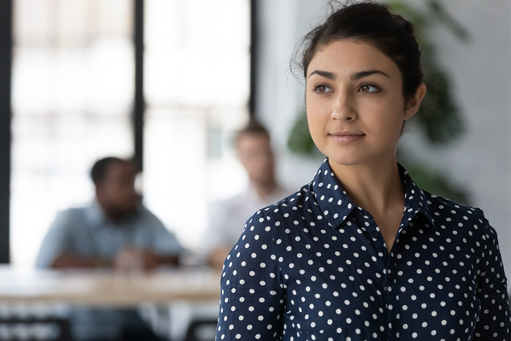 Young business woman looks off into the distance