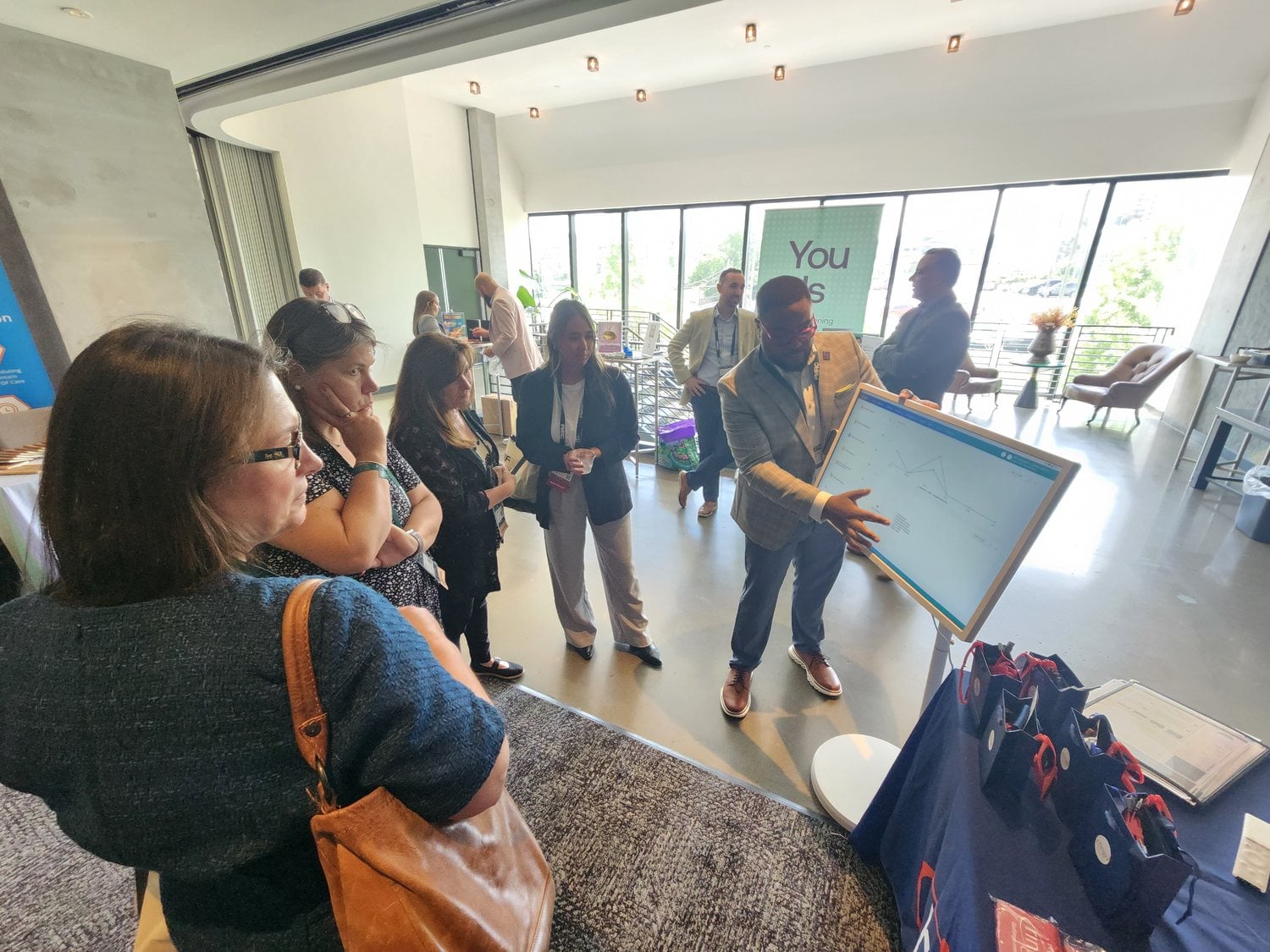 Attendees watching a live Ringo VMS walkthrough at a conference