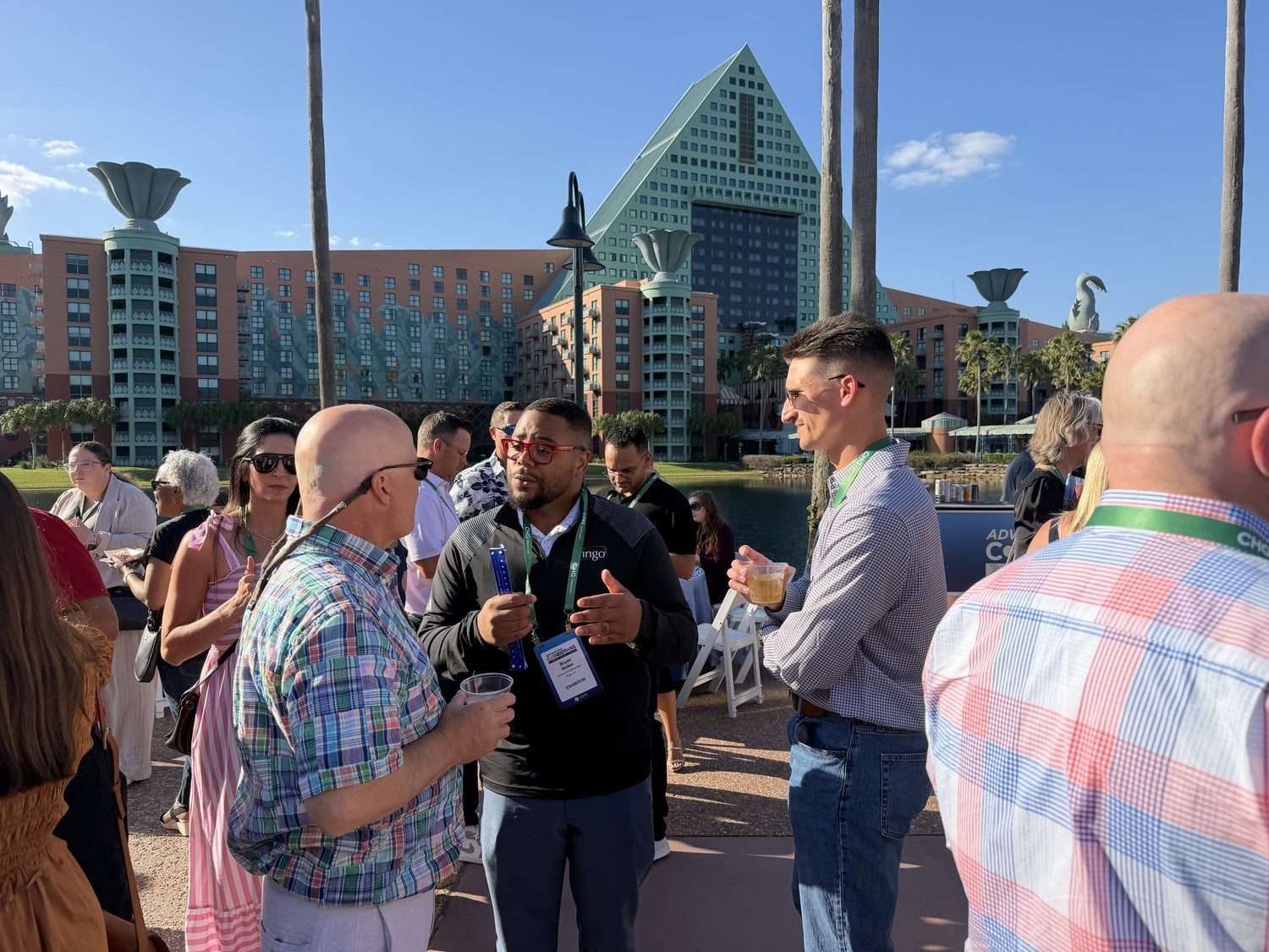 Ringo team and attendees talking at an outdoor evening reception in Orlando